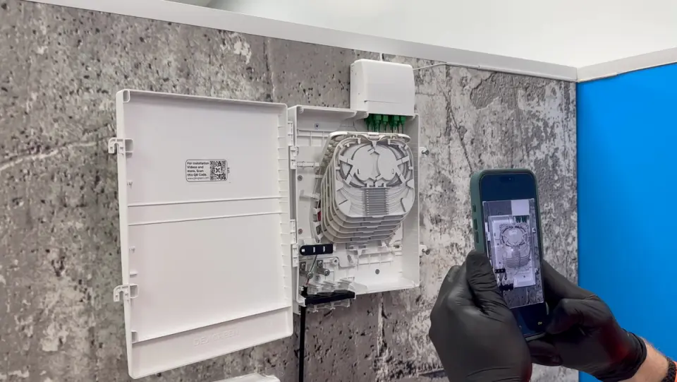 Engineer scanning a fibre cabinet with Forge on a phone